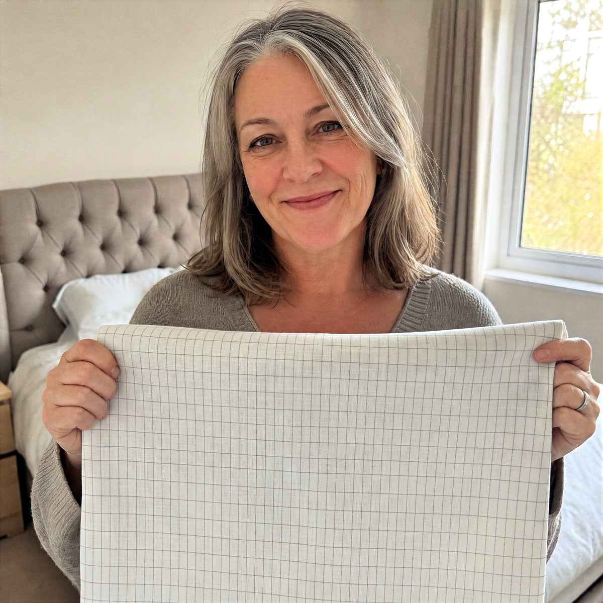Eleanor Hartley, WellNatura founder, holding the grounding sheet